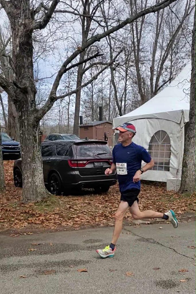 Steve Yeaton running in a fall road race, wearing a race bib